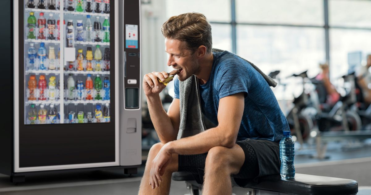 Cold drinks vending machine in use at a gym